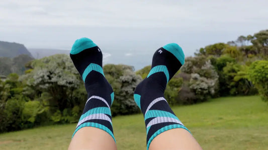 Do Better Colab Chevron Strike Organic Cotton Crew sock on feet with ocean and parkland in the background
