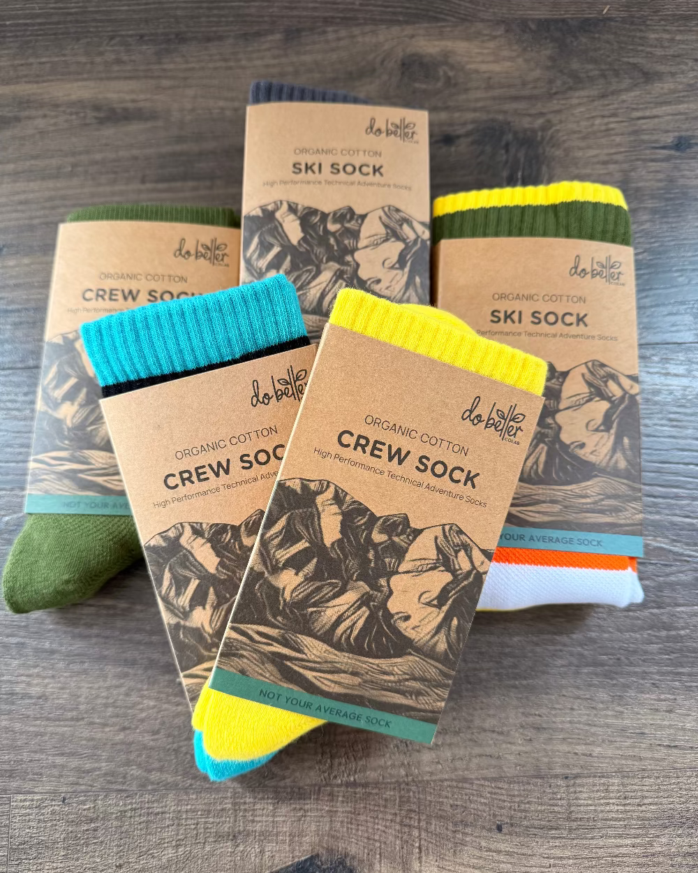 two ski and three crew socks in their packaging on a wooden floor